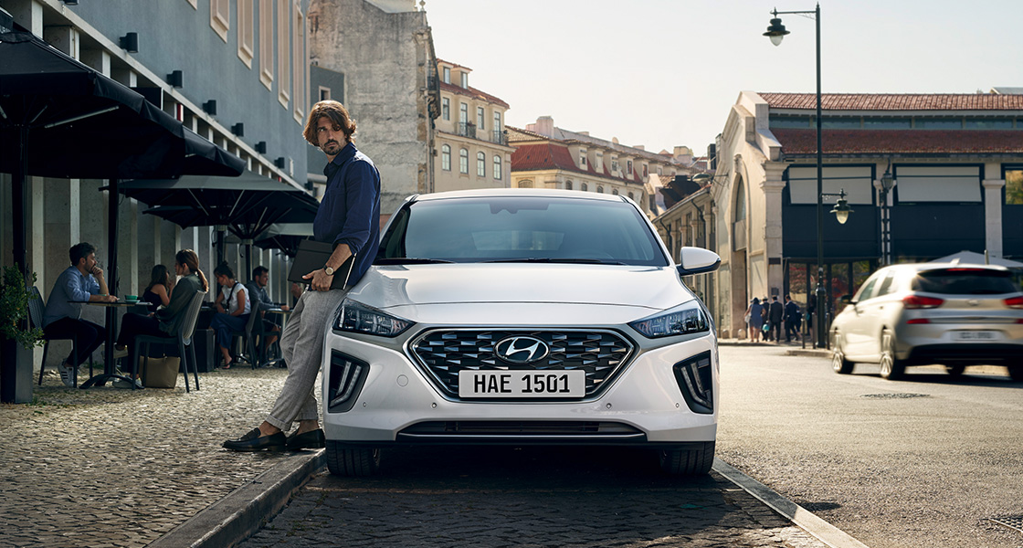 White Ioniq hybrid is driving.